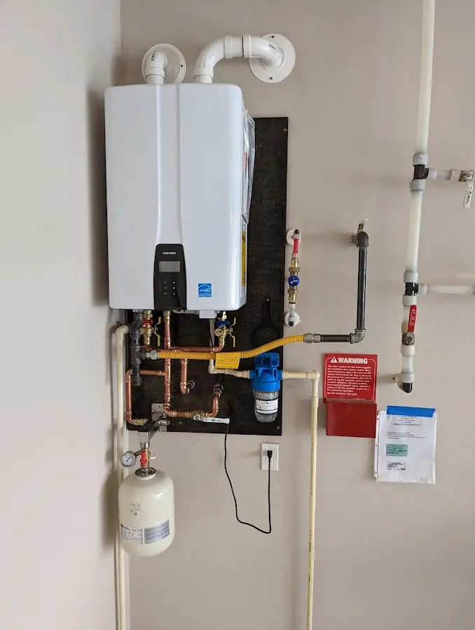 Professional plumber installing copper piping in a Lenexa home